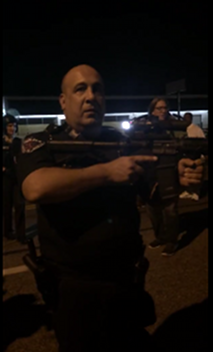 "Officer Go Fuck Yourself" aiming rifle at protestors and journalists, Ferguson, MO, August 19, 2014. (http://www.deathandtaxesmag.com/).